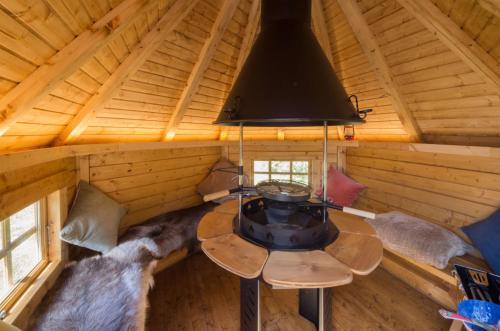 an attic room with a table in a log cabin at Wildcat Lodge in Kilmichael Glassary