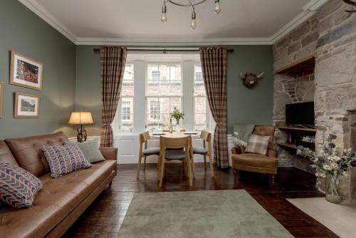a living room with a couch and a table at Rose Apartment in Edinburgh