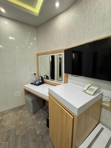 an office with a desk with a phone and a computer at Rose Land Hotel in Umm Lajj