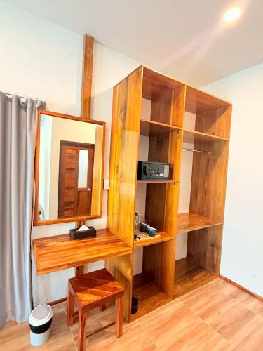 a room with wooden shelves and a mirror at Sea Beach at Lipe in Ko Lipe