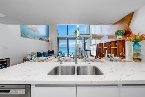 a kitchen with a sink and a large window at Napili Point C3 · NP C3 Renovated OceanFront to Whale Watch Rela in Kahana