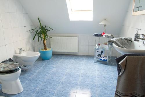 a bathroom with a toilet and a sink at Ferienhaus Betty in Rhauderfehn