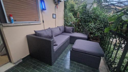 a couch and ottoman sitting on a patio at Le Stanze di Bimba in Terni