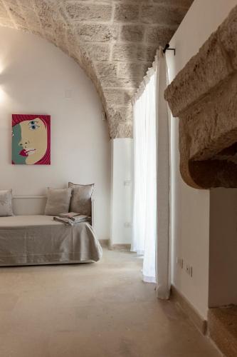 a bedroom with a bed and a large window at Masseria San Rocco in Gallipoli