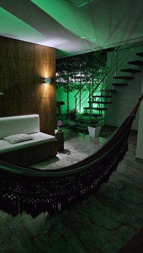 a room with a hammock in the middle of a room at Lugar Aconchecante 2 Ap 102 in Palhoça