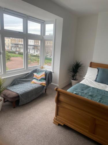 a bedroom with two beds and a window at Harbour Harmony 3 bed apt in Ramsgate in Ramsgate