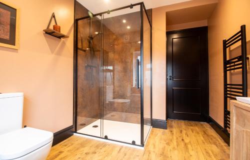 a glass shower in a bathroom with a toilet at Our Home from Home in the heart of Abergavenny in Abergavenny