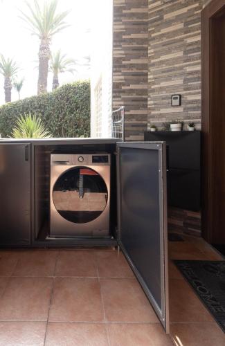 a microwave oven with its door open on a patio at L Évasion ZEN Duplex d Exception Entre Plage et Serenite in Mohammedia
