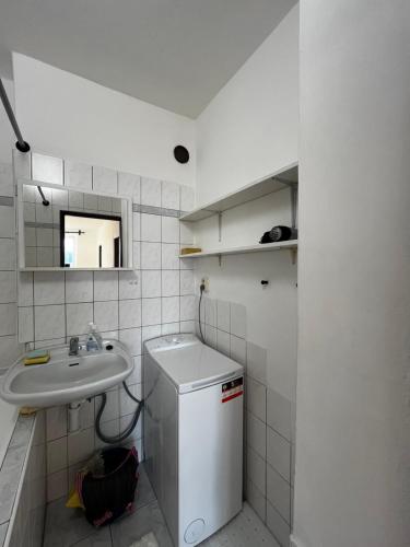 a small bathroom with a sink and a small refrigerator at 2-izbový apartmán s výhľadom in Spišská Nová Ves