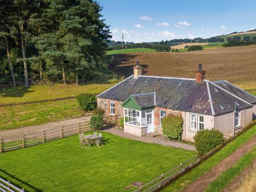 an aerial view of a house in a field at Clayhills Cottage - Uk5833 in Rattray