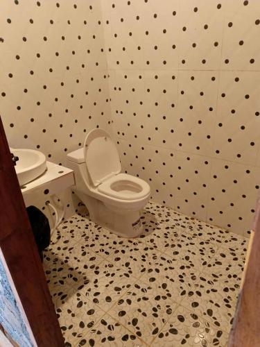 a bathroom with a toilet and a sink at Avocados homestay in Banlung