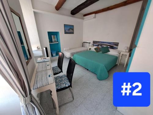 a bedroom with a bed and a couch and a table at Le Stanze del Barbara in Vernazza
