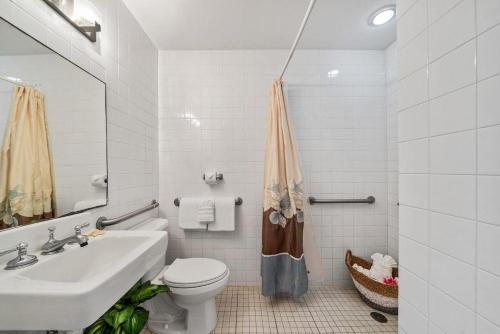 a white bathroom with a sink and a toilet at Lahaina Shores PH1 · LS PH1 Oceanfront Penthouse Condo w Panoram in Lahaina