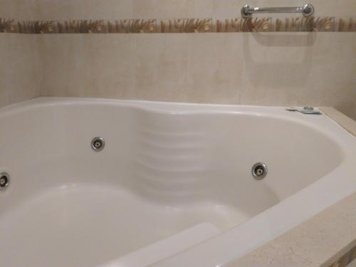 a white bath tub in a bathroom at Hotel A&B Internacional in Buenos Aires