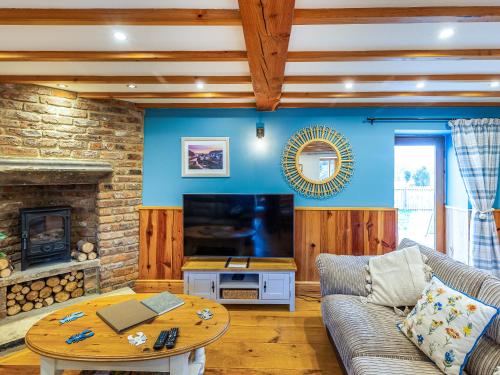 a living room with a couch and a table at Seaton Cottage - Uk31990 in Staithes