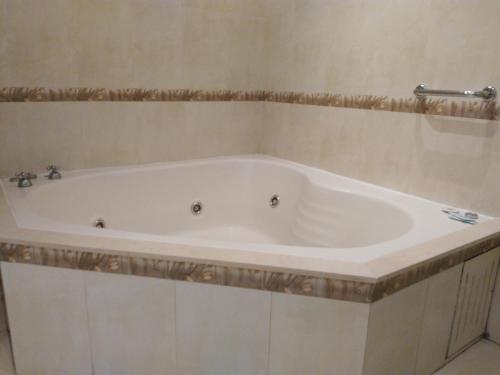 a white bath tub in a bathroom with at Hotel A&B Internacional in Buenos Aires