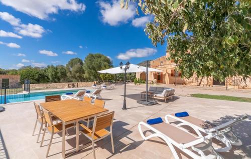 a patio with a table and chairs and a pool at Son Pons in Randa