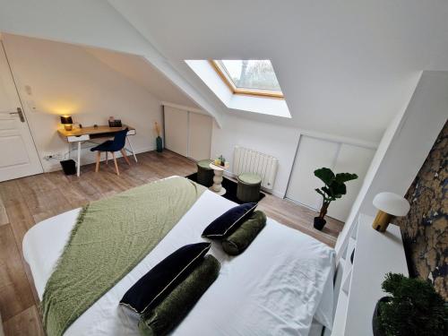 a bedroom with a bed with pillows and a desk at Beautiful High-End Duplex 2 Bedrooms in Hautmont