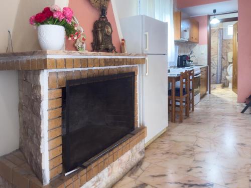 a living room with a brick fireplace in a kitchen at SIX INDEPENDENT HOUSES BY THE sea in Glífa