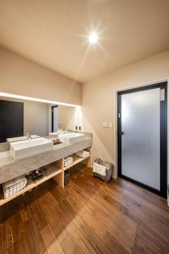 a bathroom with a large sink and a large mirror at Sky deck for rent! Fuji view Open-air bath New building in Fujiyoshida