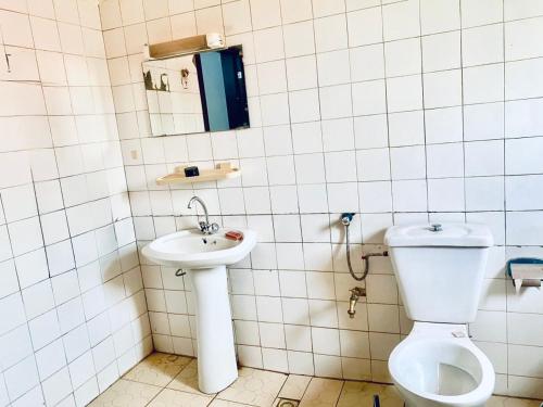 une salle de bains avec toilettes et lavabo dans l'établissement MandéHabitat, à Bamako