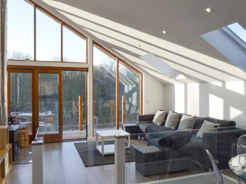 a living room with a couch and some windows at Waterside Lodge Sixteen - Uk13038 in Southowram