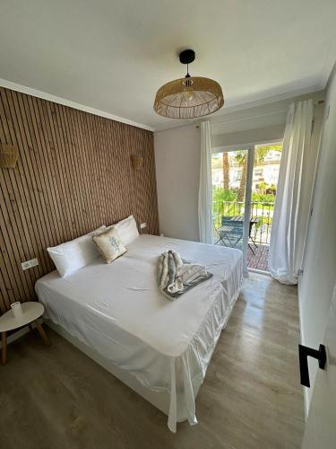 a bedroom with a bed with a towel on it at ThE WHALE HOUSE in El Campello