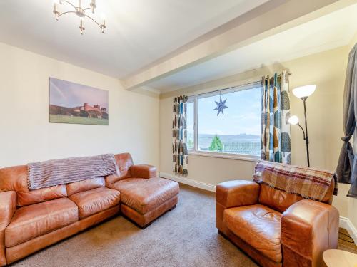 a living room with a couch and chairs and a window at Adderstone Folly in Belford