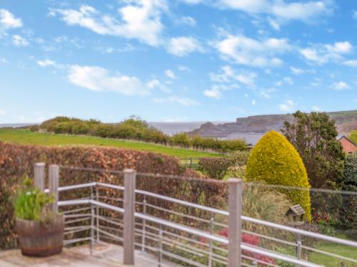 a view from the garden of a house with a fence at Highfields in Runswick