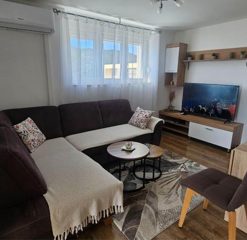 a living room with a couch and a flat screen tv at The View in Ploče