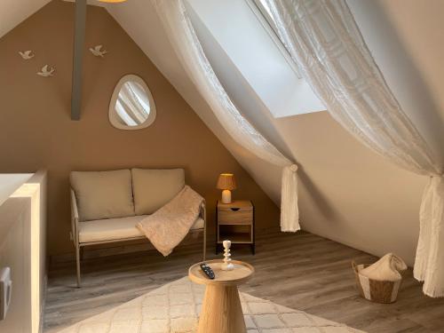 a attic room with a chair and a window at Vue Cathedrale, Elegance & Lumière à Amiens in Amiens
