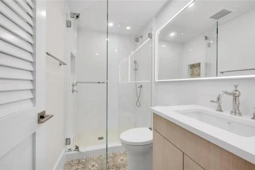 a bathroom with a shower and a toilet and a sink at Gulf-front Masterpiece in Naples