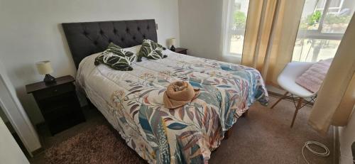 a bedroom with a bed with a teddy bear on it at Habitacion Matrimonial privada en machali con parcking y wifi in Rancagua