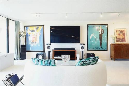 a living room with a white couch and a tv at Spacious Three Bedroom Condo with Lake Views in Lakeside Green