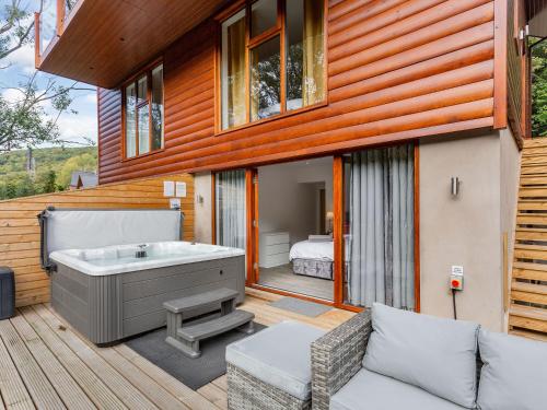 a house with a tub on a deck at Waterside Lodge Five -Uk38263 in Southowram
