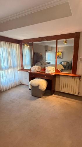 a bedroom with a desk and a mirror at Decimo in Villa Mercedes