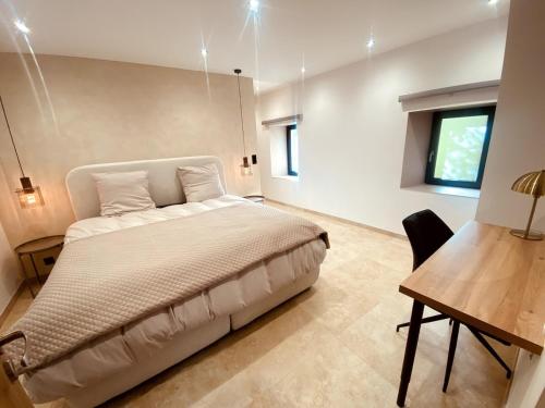 a bedroom with a bed and a table and a desk at Appartement Fiorentina in Saint-Avold
