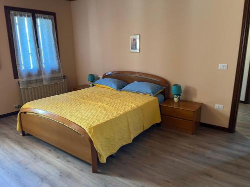 a bedroom with a bed with a yellow bedspread at Guest House Al Capitello 