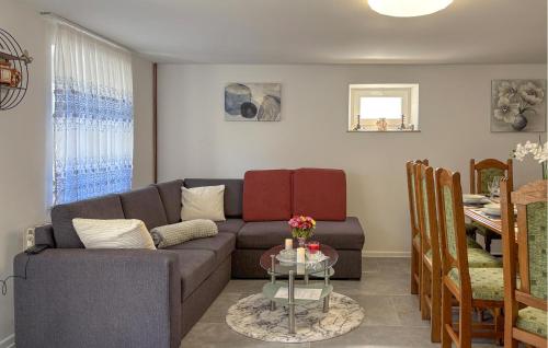 a living room with a couch and a table at 2 Bedroom Cozy Home In Salopeki Modruski in Modruš