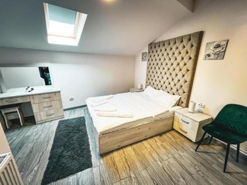 a bedroom with a large bed and a sink at Splendor Bratianu in Piteşti