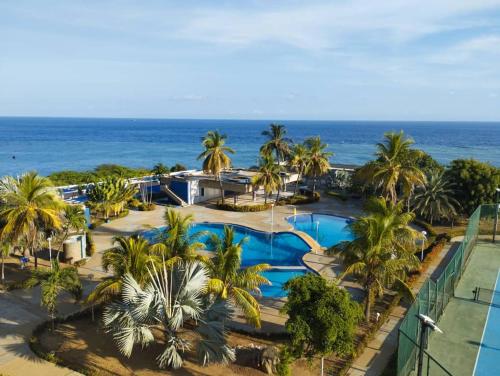 an aerial view of a resort with palm trees and the ocean at Ocean view apartment near the airport in Maiquetía