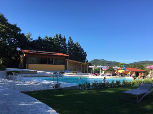 a swimming pool with people in a resort at villaggio casina del duca in Pescolanciano