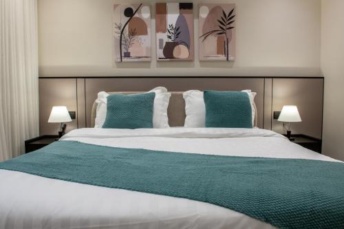 a bedroom with a large bed with blue pillows at Mabaat-Deluxe 1BR Al Waha 621 in Jeddah