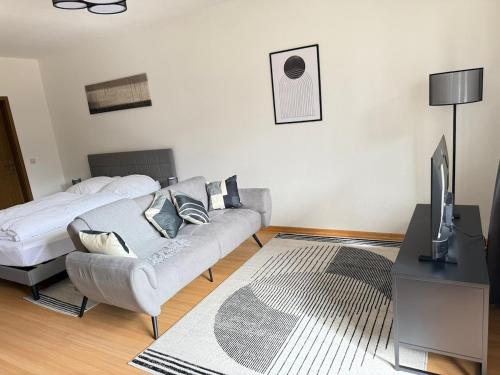 a living room with a couch and a bed at FEWO mit Balkon in Osnabrück