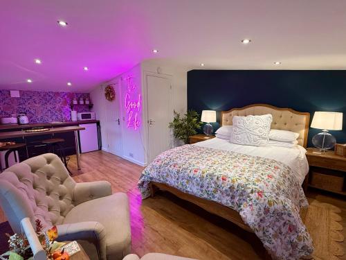 a bedroom with a large bed and a purple ceiling at Oak View Lodge: Cosy, Countryside Retreat in Maybole