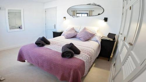 a bedroom with a bed with black towels on it at Apartamento, Arena, Primera linea Mar, sea views in Playa Honda
