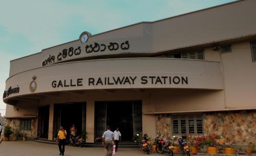 a building with motorcycles parked in front of it at Princely House Apartment in Galle