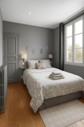 a bedroom with a large bed and a window at Maison de L'Octroi in Chartres