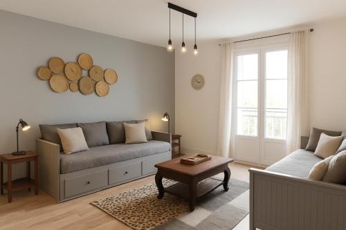 a living room with a couch and a table at Appartements de l'Octroi avec parking in Chartres