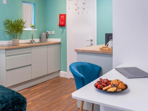 a kitchen with a table with a plate of food on it at Hilltop Apartment 4 - Uk50596 in Earl Shilton